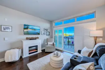 Living room with cozy fireplace and slider out to spacious view patio.