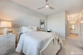 Primary ensuite with grand walk-in closet and spa bath.