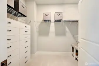Primary walk-in closet with built in organizers.