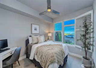 Guest bedroom with shutter open to showcase the breathtaking views.