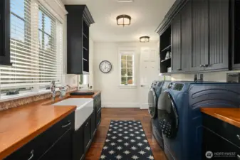 Main floor laundry center with a 3/4 bath around the corner and access to the driveway portico