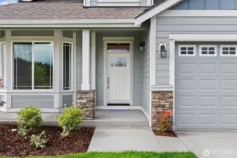 Our Redwood one story floor plan has the perfect covered porch entry with stone accents to welcome you and your guests.