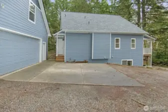 Side view of home with back door access and gate into the backyard and patio.