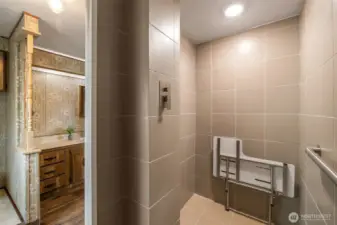 Newer ceramic tiled, wide shower with seat