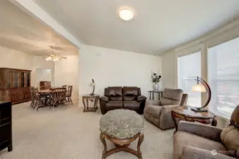 This spacious front living room is framed by a large bay window on the right