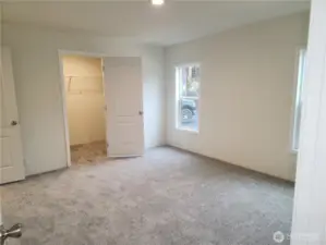 Spacious primary bedroom with large walk-in closet and to the left is the ensuite.