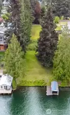 Drone view of lot and boat dock on right.