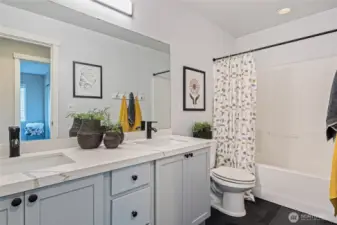 Updated upstairs bathroom with dual sinks and granite countertops.
