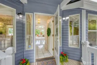 A warm and stylish welcome awaits at the front door, where a covered porch and peekaboo views into the living space invite you inside with a glimpse of what’s to come.