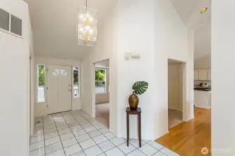 Bright and open, the entry hall boasts marble tile floors and a high ceiling. A graceful transition space that sets the tone for the rest of the home’s welcoming interior.