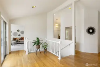 The upper landing offers a graceful flow between spaces and access to the large back deck. Natural light pours in, making it an ideal spot for displaying art, plants, or simply enjoying the openness of the layout.