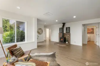A cozy corner in the living area showcases a wood-burning stove with a brick hearth perfect for warming up on cool evenings and adding rustic charm to the room.