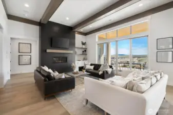 Great room area with fireplace and beams.