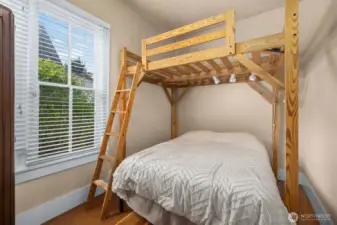 Main floor BR.  Solidly-built mattress loft stays for next owner.