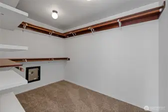 Huge primary closet has a built in safe in it