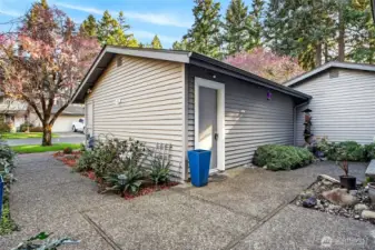 Garage rear entry with clean lines, low-maintenance landscaping & peaceful setting. Well-kept exterior offers functional access & added privacy.