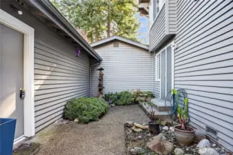 Private patio space with low-maintenance landscaping, decorative fountain & cozy seating area. Quiet setting ideal for relaxing or outdoor enjoyment.