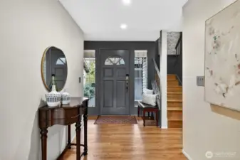 Bright, welcoming entry with hardwood floors. Neutral tones, natural light & clean lines create a warm, inviting first impression.