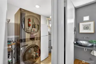 Convenient laundry area with full-size washer & dryer plus storage space. Adjacent powder room adds function & efficiency to the main level layout.