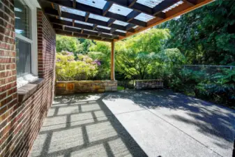 Private custom patio off of living room with covered area for year-round outdoor enjoyment.