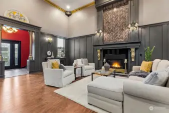 Impressive board and batten wainscot and regal crown molding highlight the 17 foot ceilings in the living room, with a floor-to-ceiling showpiece gas fireplace with gas insert that fills the room with cozy heat and ambiance.