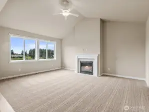 Lovely, vaulted ceilings in living room. Ceiling fans are standard in living rooms and primary bedroom