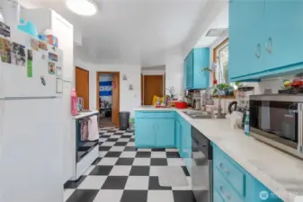 Light and bright kitchen with a plethora of cabinets and updated counters