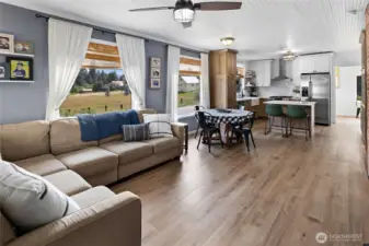 Spacious living area showcases new Luxury Vinyl Plank flooring. Pretty & Practical!