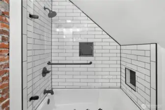 Exposed historic brick & new tiled tub/shower surround.