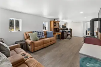 Basement Rec Room with new LVP flooring & a toasty wood stove! Basement is also plumbed for propane!