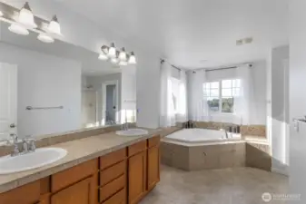 Primary suite is very spacious with double sinks, double corner window and separate shower.  A walk in closet that fits plenty.