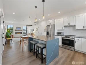 LVP flooring throughout the main floor with open kitchen, living and dining spaces.