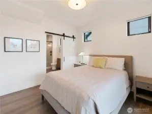 Barn door access to the owner's suite bathroom.