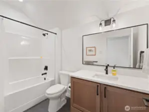 Upstairs additional full bathroom with tub/shower and tile floors.