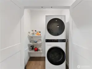 Laundry closet is on the main floor and offers space for a full-size stacking unit and additional storage.