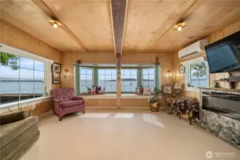 Light-filled living area with expansive windows drawing in the water views.