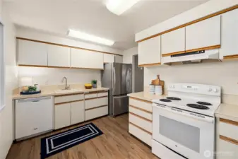 Circular kitchen design with access to both the hall and dining room for easy flow.