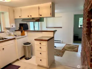 Kitchen, eating space and entry in the distance