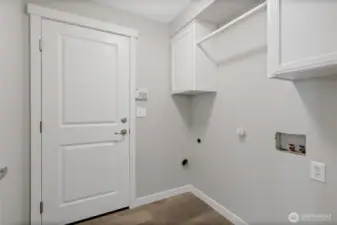 Laundry room newer washer and dryer are being stored in garage for flooring replacement