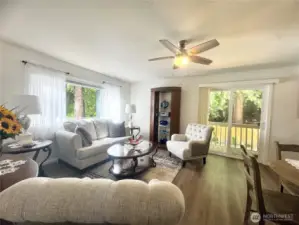 Living room features sliding doors that open to a spacious deck.