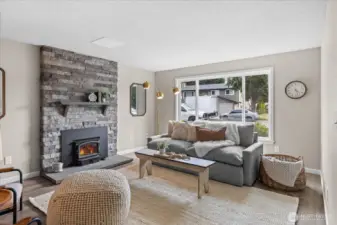 Appreciate the stunning stone fireplace and mantle with a wood burning stove.