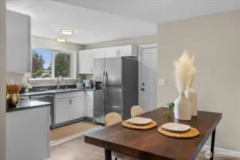 Kitchen offers SS appliances, newer cabinets, counters and lighting PLUS easy access to garage!