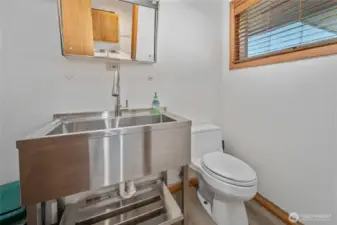 Half bath adjoins laundry; brand new stainless steel utility sink