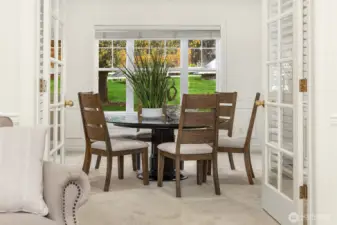 Formal dining off the formal living room, separated by elegant french doors.
