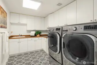 Utility room on main features a sink and tons of storage.