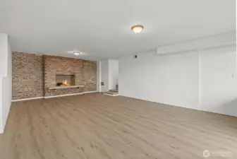 Recroom with wood burning fireplace.
