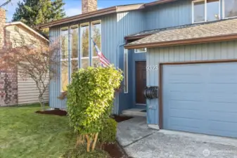 Front of house with well maintained landscaping, large double doors and new exterior paint.