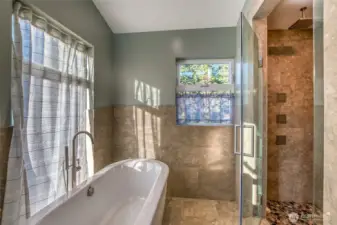 Primary Bathroom spa bathtub and double rain shower heads.