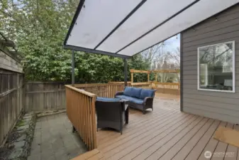 Beautiful covered outdoor living area with bench seating and trellises!