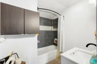 Full bathroom with updated vanity and mirror